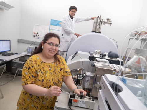  (l. to r.) Shruti Masand (GSN '22) and Ashutosh Sahoo (GSN '25) work on a MALDI-TOF Uetroflextreme machine in the Life Science Center on the Newark campus.