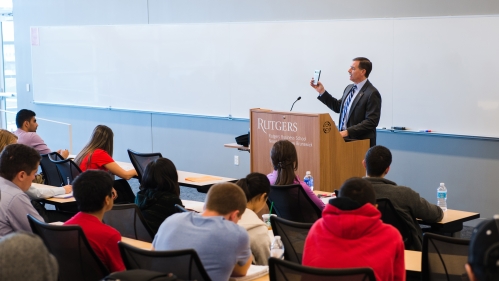 business school professor lecturing at podium