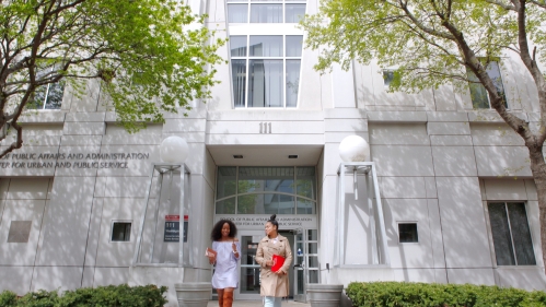 two students walking out of the spaa building