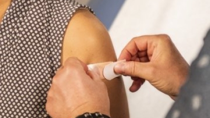 Band Aid being adhered to arm