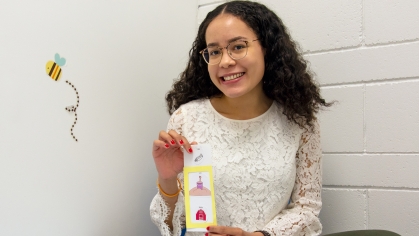 carla macias holding a flash card