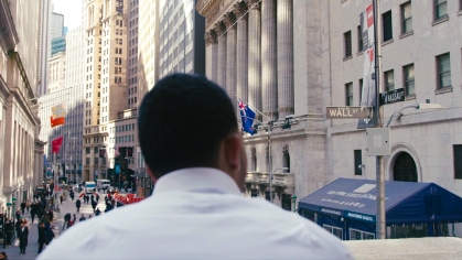 man looking out over wall street