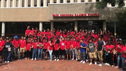 students with red rutgers shirts standing for group photo