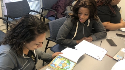 Two women at table learning