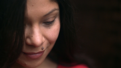 Marisol Conde-Hernandez looking down and smiling pensively