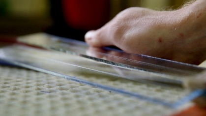 hand on top of glass sculptures for the glassbook project