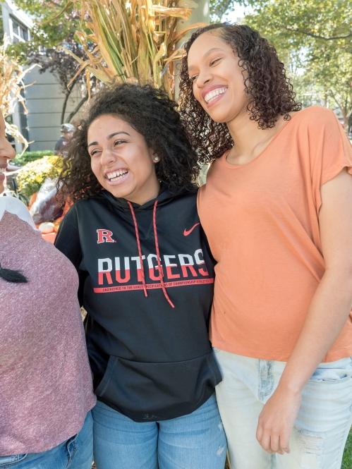 three women outside laughing together