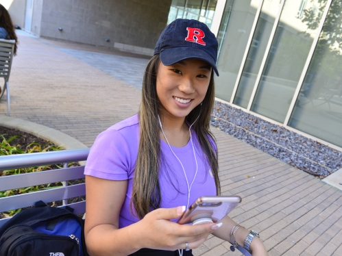 woman smiling holding phone