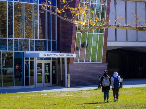 students walking on building lawn