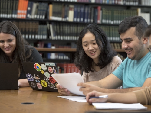 students in library on laptops