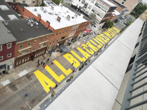 "all black lives matter" printed in large yellow letters across a newark street