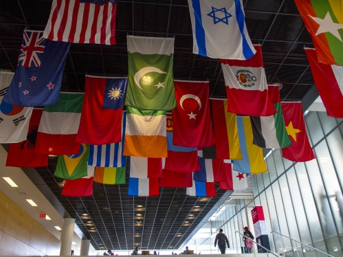 multiple country flags hanging from the ceiling