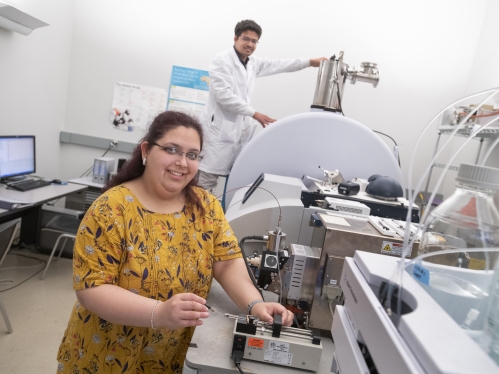 (l. to r.) Shruti Masand (GSN '22) and Ashutosh Sahoo (GSN '25) work on a MALDI-TOF Uetroflextreme machine in the Life Science Center on the Newark campus.