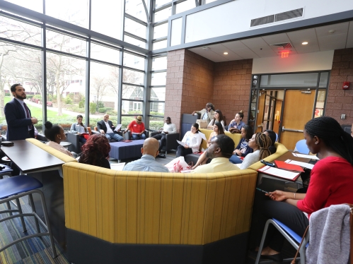 several diverse students sitting in a lounge and working