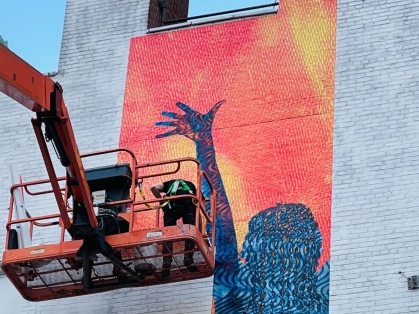 mural celebrating womanhood being erected