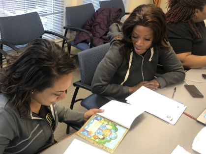 Two women at table learning