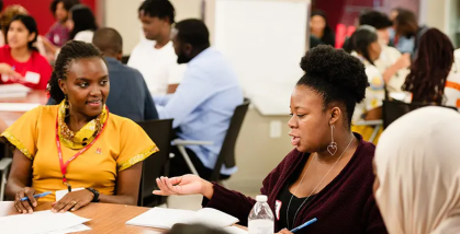 etta madete working with students at the supply chain summer program